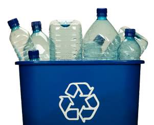 Blue recycling bin with plastic bottles sticking out of the top